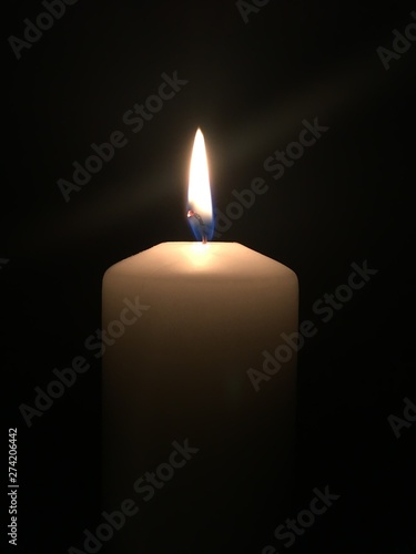 A lonely candle burning in the dark
