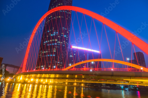 Tianjin Hai river waterfront downtown skyline with illuminated Dagu bridge,China. © hallojulie