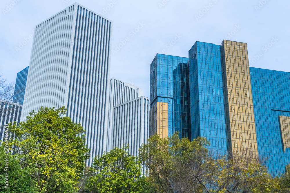 modern office building with green trees.