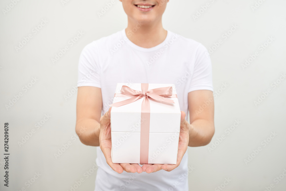 A happy handsome man presenting some gifts. Isolated on white background. A happy handsome man presenting some gifts. Isolated on white background.