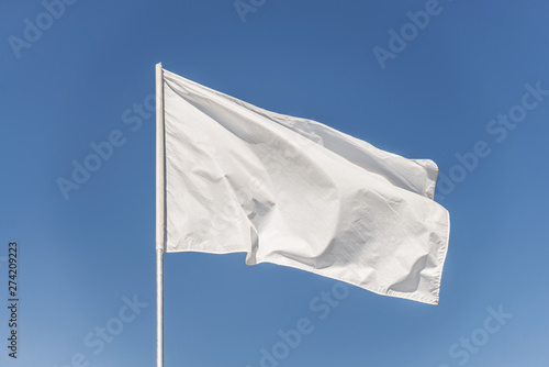 White flag against the blue sky