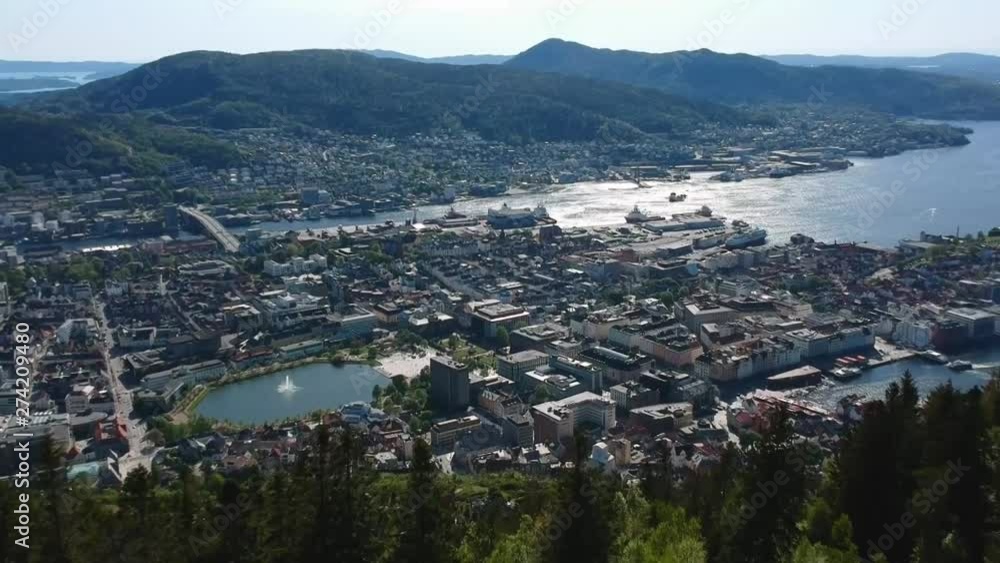 Drone shot of treetops looking over the city of Bergen, Norway. Drone shot of treetops looking over the city of Bergen, Norway.