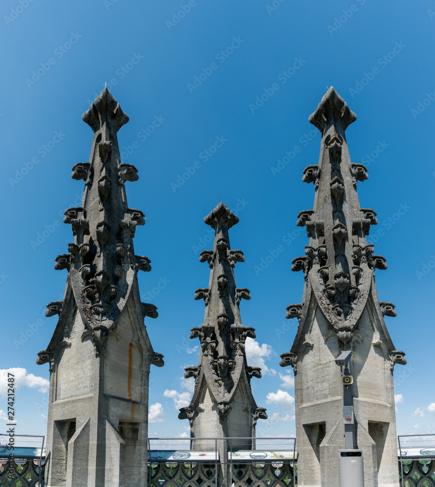 the spires of the historic cathedral in Fribourg under a blue sky with white clouds the spires of the historic cathedral in Fribourg under a blue sky with white clouds