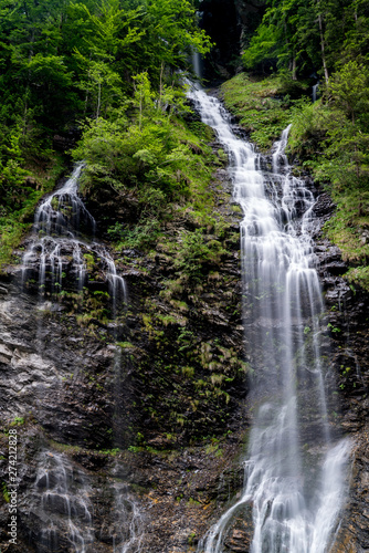 panorama of high picturesque waterfall in lush green forest landscape