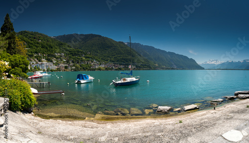 boats on the shores of Lake Geneva with great view of the Swiss Alps behind as seen from the Montreux Riviera