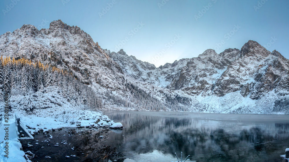 Fototapeta premium Winter mountains. High Tatra Morskie Oko lake, Poland. Scenic winter landscape of rocky mountain range covered snow