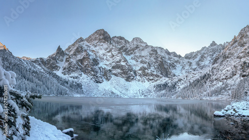 Winter mountains. Winter background. Christmas and New Year vacation concept. winter mountain. Snowy rocks and ice lake. Morning winter landscape © dzmitrock87