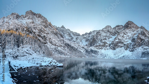 Winter mountains. High Tatra Morskie Oko lake, Poland. Scenic winter landscape of rocky mountain range covered snow