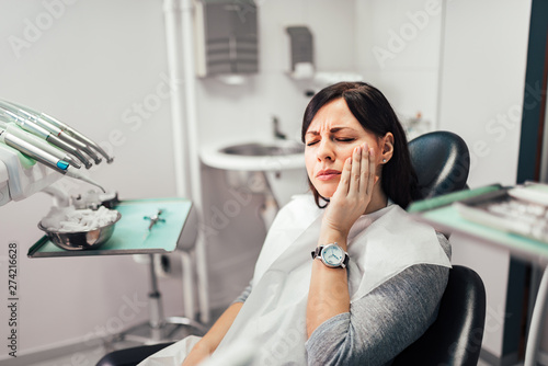 Woman with toothache at dentist office. photo