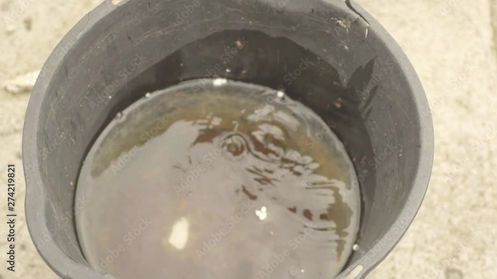 Bucket catching leaking water drops Bucket catching leaking water drops