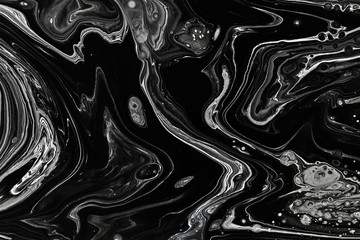Abstract black marble texture background. Oil, acrylic paint mix pattern.