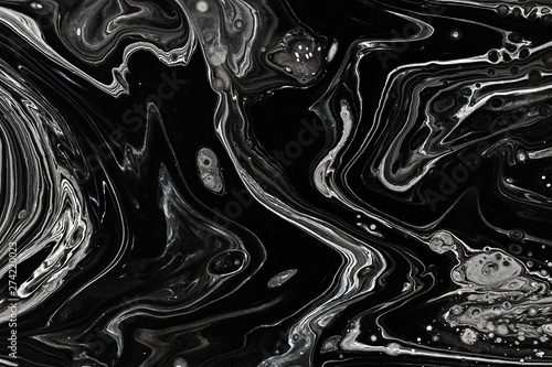 Abstract black marble texture background. Oil, acrylic paint mix pattern.