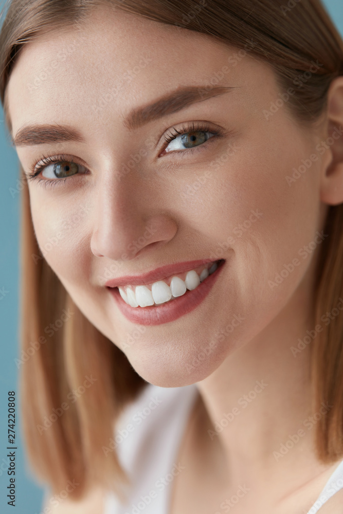 Smiling woman with beauty face and white teeth smile closeup Smiling woman with beauty face and white teeth smile closeup