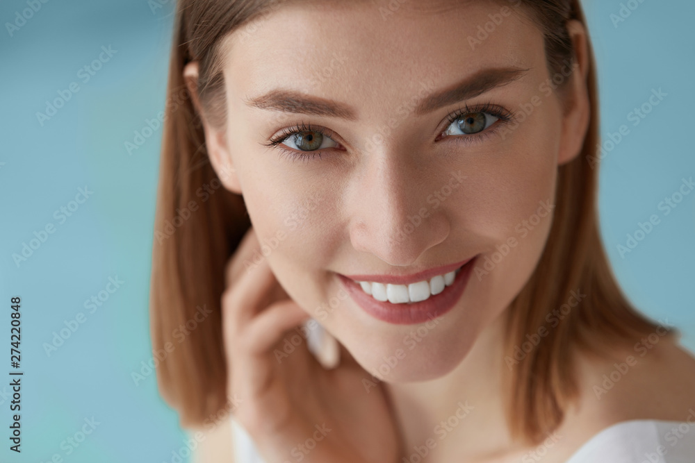 Smiling woman with beauty face and white teeth smile closeup Smiling woman with beauty face and white teeth smile closeup