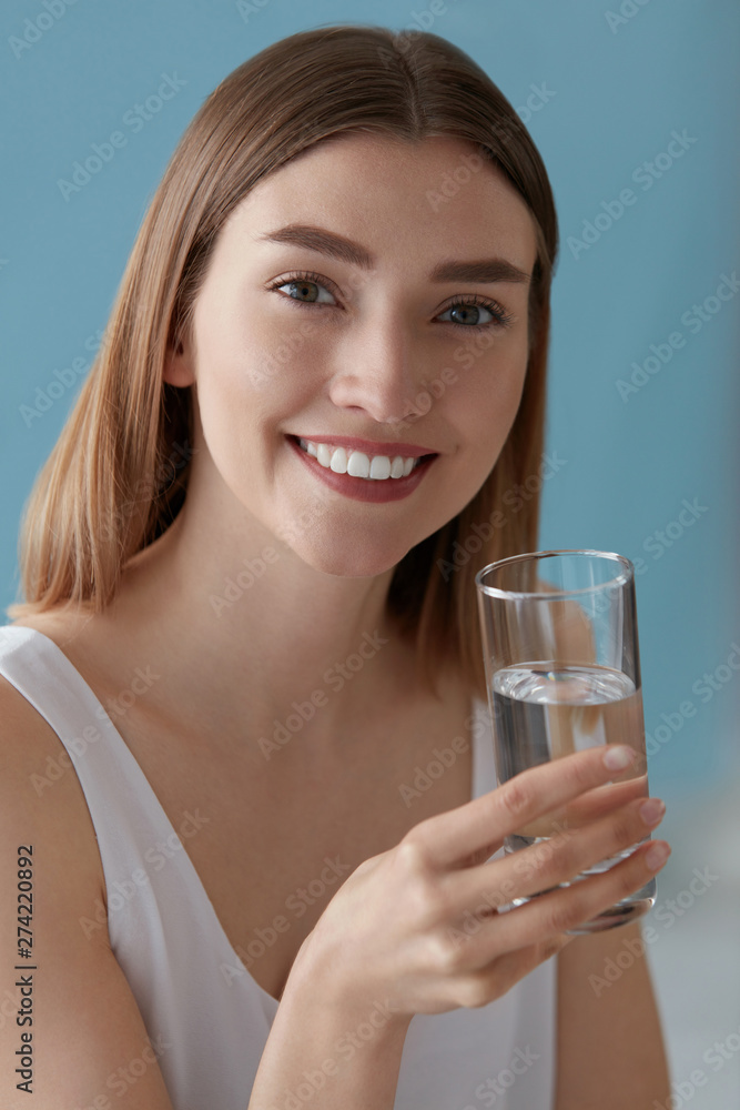 Smiling woman with glass of water indoors portrait Smiling woman with glass of water indoors portrait