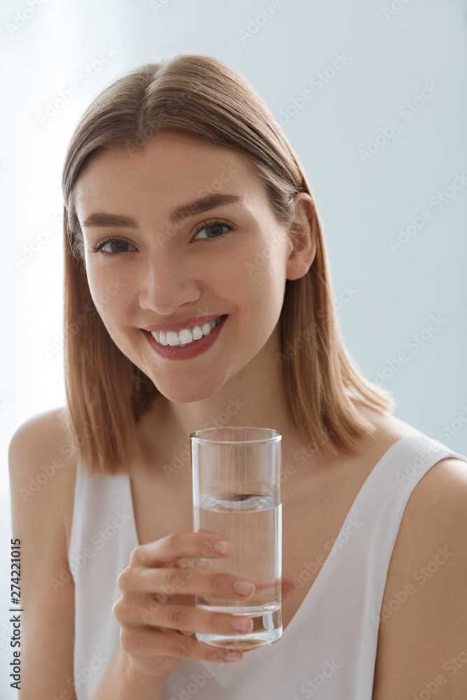 Woman with glass of fresh water in white portrait Woman with glass of fresh water in white portrait
