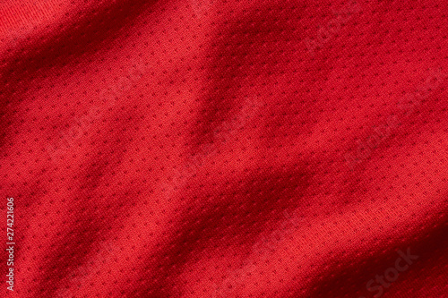 Red fabric sport clothing football jersey with air mesh texture background © Kwangmoozaa