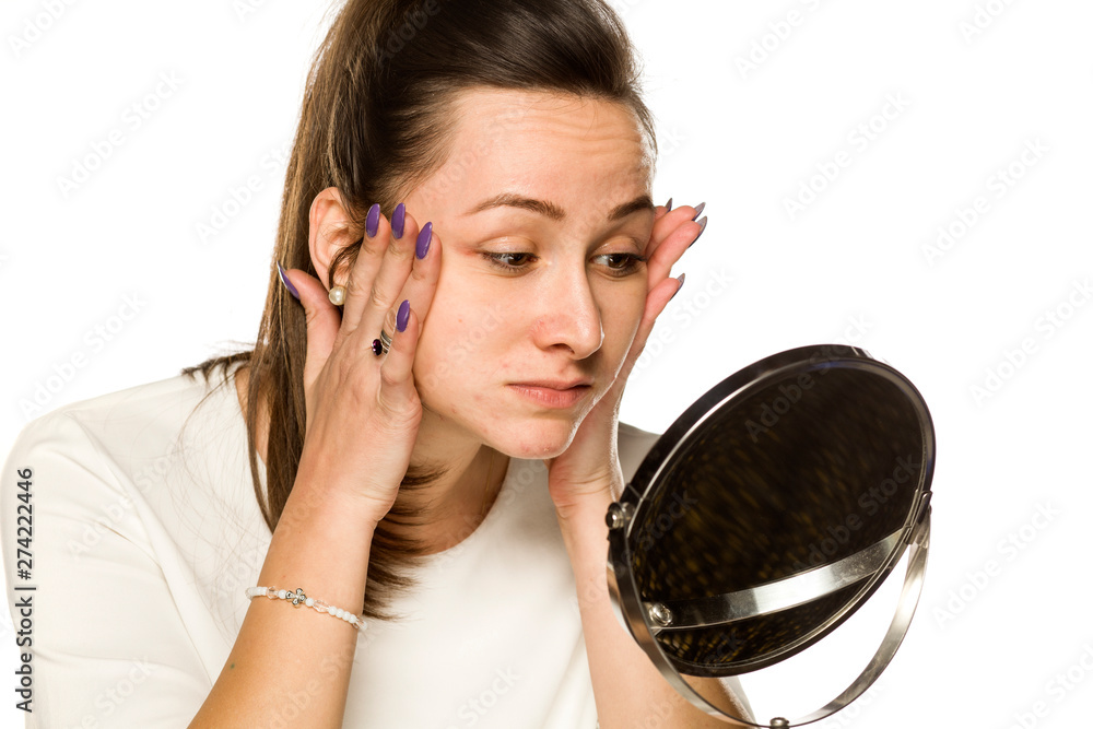 A woman tightening her face on white background