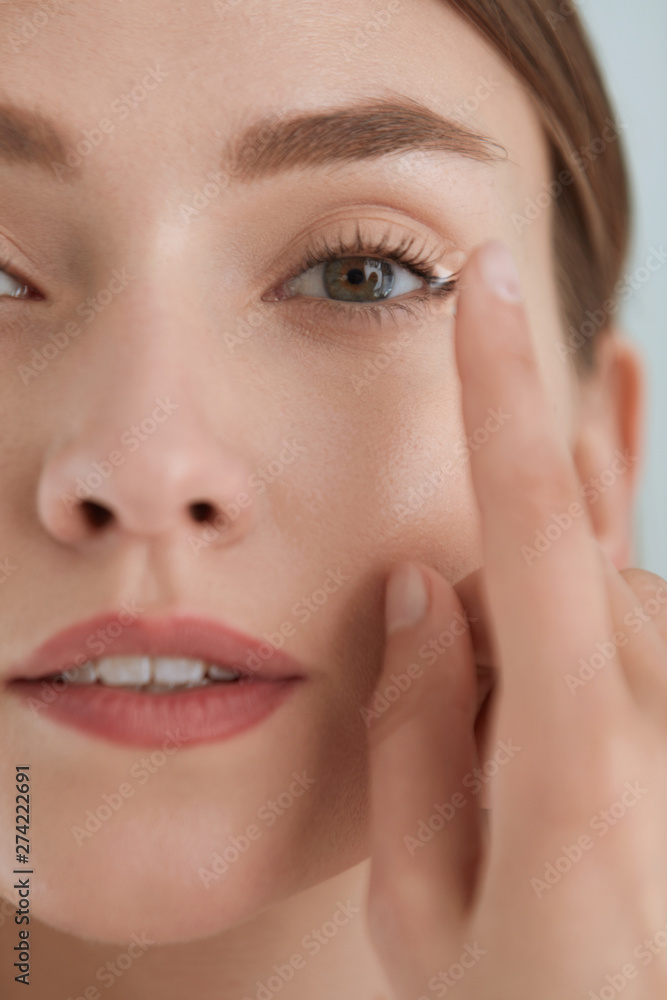 Contact eye lens. Woman applying eye contacts on eyes closeup Contact eye lens. Woman applying eye contacts on eyes closeup