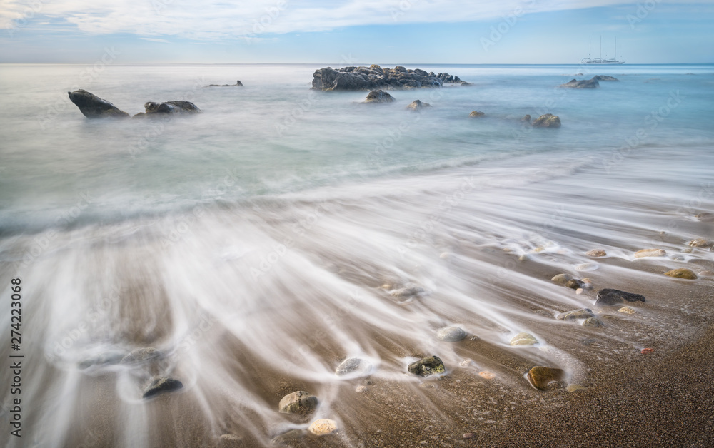 Long exposure shot of Ionian sea vail on the beach of Giardini Naxos, Sicily, Italy Long exposure shot of Ionian sea vail on the beach of Giardini Naxos, Sicily, Italy