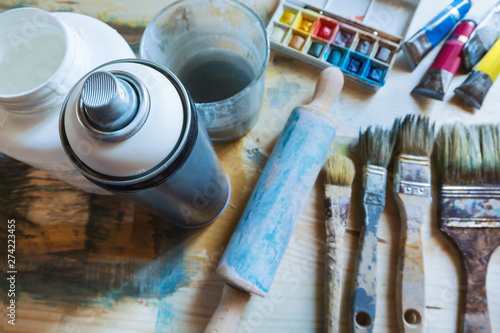 Spray can and tools of artist on the table
