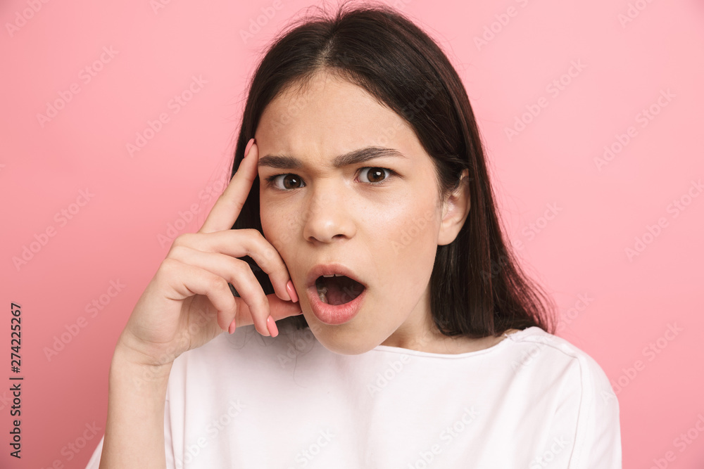 Portrait closeup of brunette excited girl in casual wear looking at camera with open mouth Portrait closeup of brunette excited girl in casual wear looking at camera with open mouth