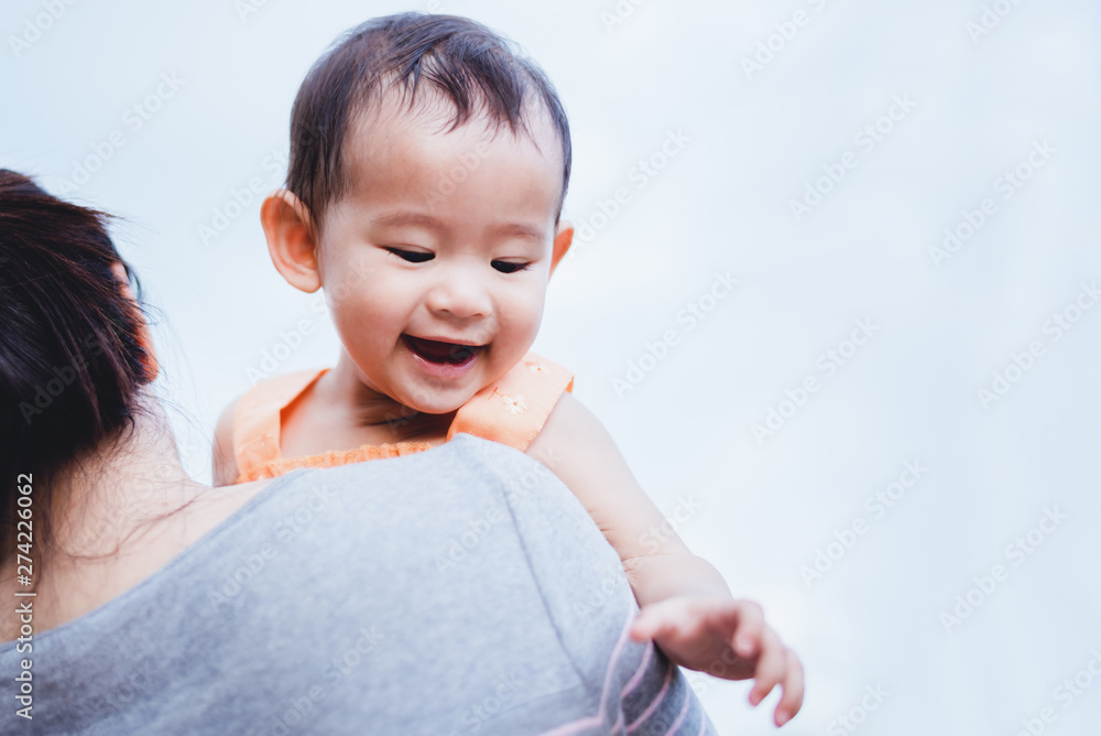 Mother raised her litlle baby on her shoulder Mother raised her litlle baby on her shoulder