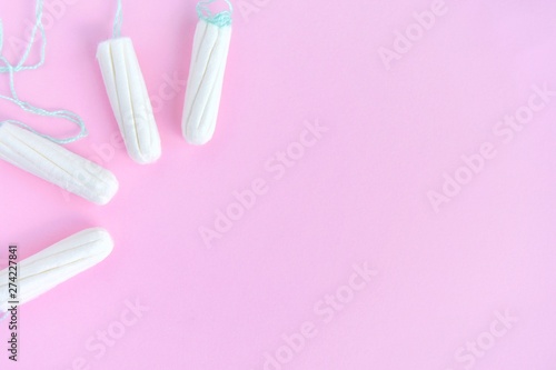 Cotton Hygienic tampons for women period days with selective focus on blurred pink background with empty space for text. Personal protection tampon for menstruated period. Females healthcare 