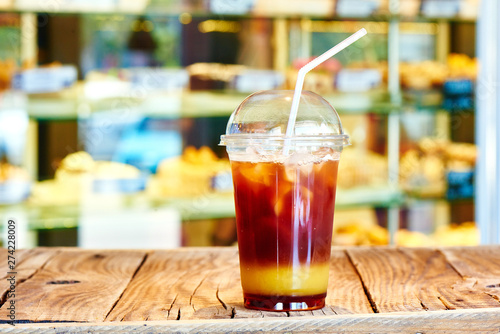 Refreshing soft colorful drinks  milk berry cocktail with cream  mojito  ice tea. Milkshake in plastic glass with straw in summer bar  nature background