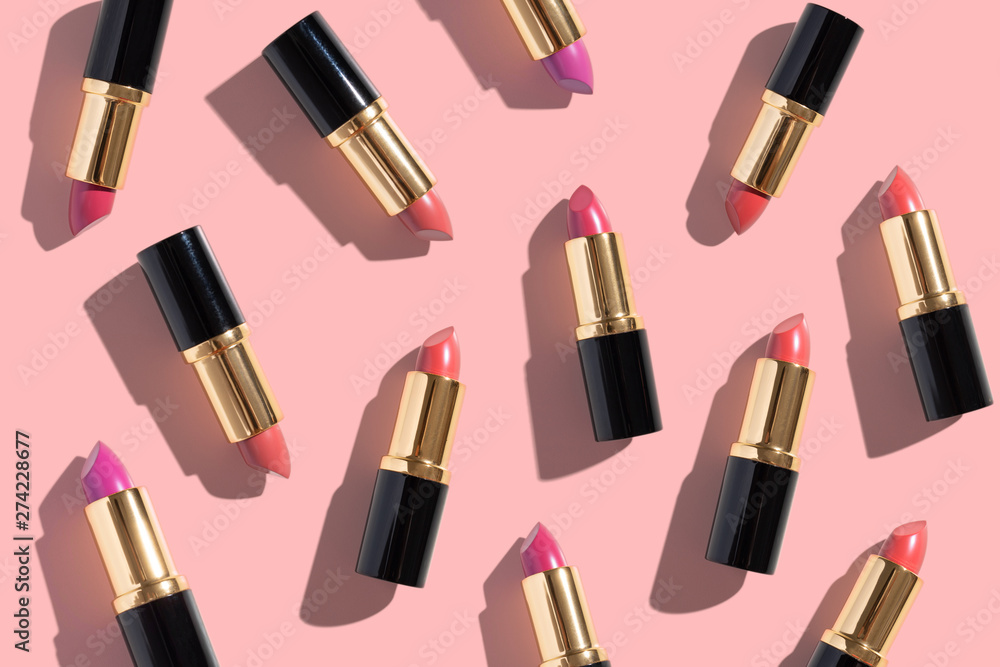 Obraz premium Set of color lipsticks on pink background. Flat lay.