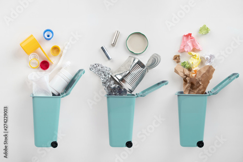 Photography Trash bins and assorted garbage on grey background