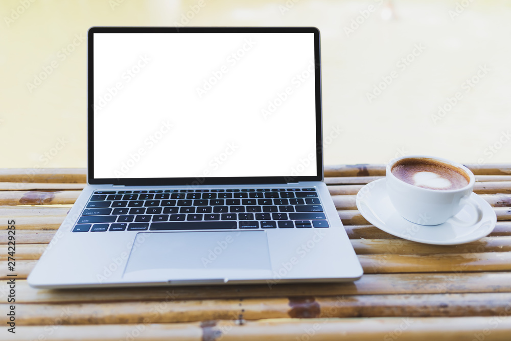 Laptop mockup and hot espresso in a white coffee mug on a bamboo table, outdoor Laptop mockup and hot espresso in a white coffee mug on a bamboo table, outdoor