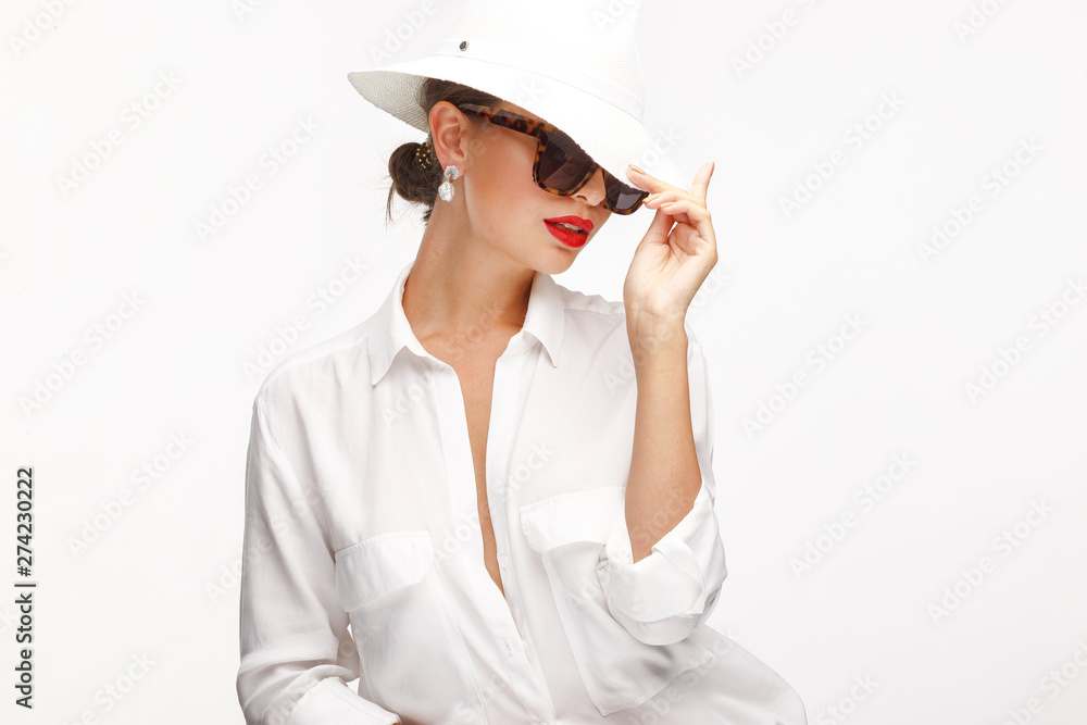 Beautiful girl in an elegant white hat, sunglassess and exquisite jewelry. Beautiful girl in an elegant white hat, sunglassess and exquisite jewelry.
