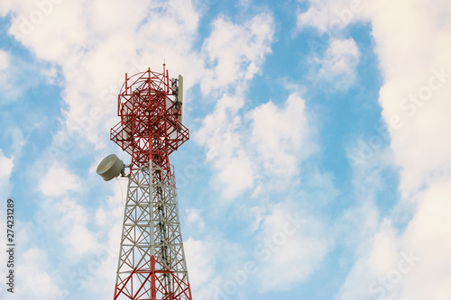 Wireless Communication Antenna Transmitter. Telecommunication tower with antennas on blue sky background.