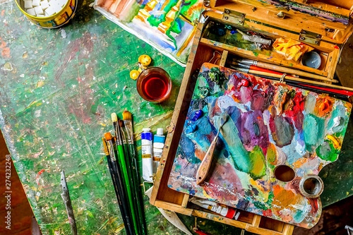 Bright Colorful workplace of the artist with brushes and oil paints
