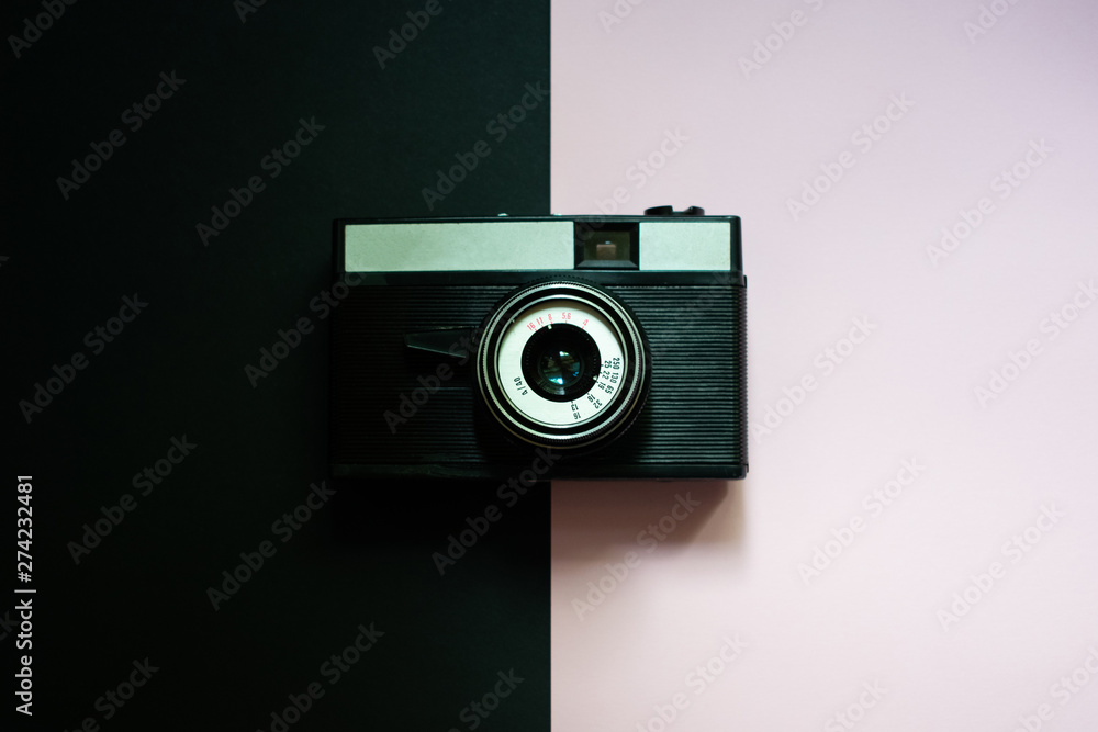Film retro camera on a black and pink background 5