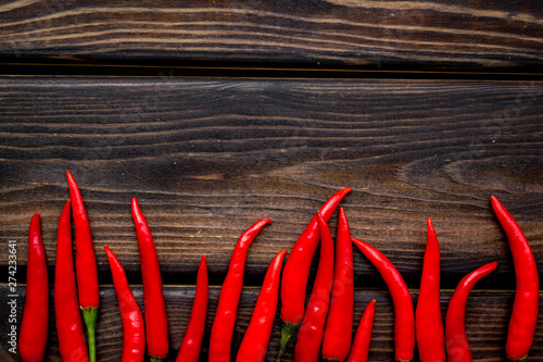 Cooking hot food with chilli pepper on wooden table background top view copy space