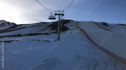 First person view of somebody goes peak of the ski resort mountain on chair