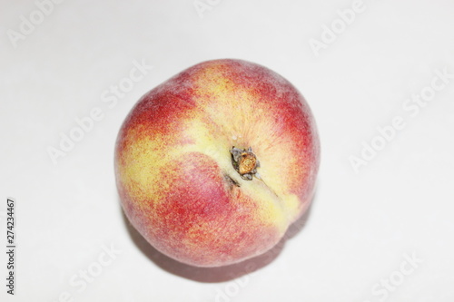Peaches lying on the table on a white background