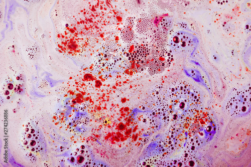 Red and purple textured surface with dissolve bathbomb photo