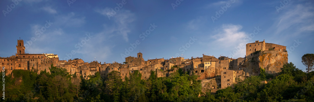 PITIGLIANO, TUSCANY, ITALY - JUNE 2019 - View of Pitigliano town, golden hour. Picturesque and unusual - built on tuff, tufo, tufaceous volcanic rock.