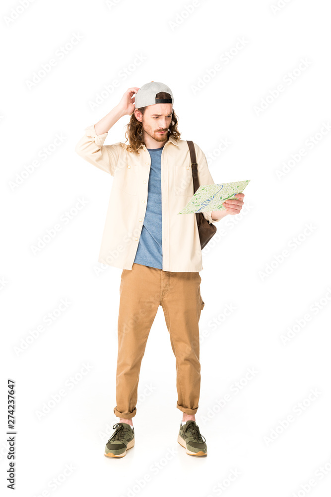 full length view of confused young man holding map isolated on white full length view of confused young man holding map isolated on white