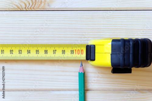 Extended measuring tape and a simple pencil