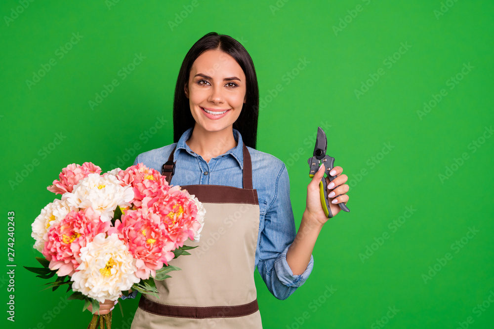 Portrait magnificent charming assistant small business representative hold hand peony tool equipment blue shirt denim jeans positive cheerful excited workstation trendy isolated green background Portrait magnificent charming assistant small business representative hold hand peony tool equipment blue shirt denim jeans positive cheerful excited workstation trendy isolated green background
