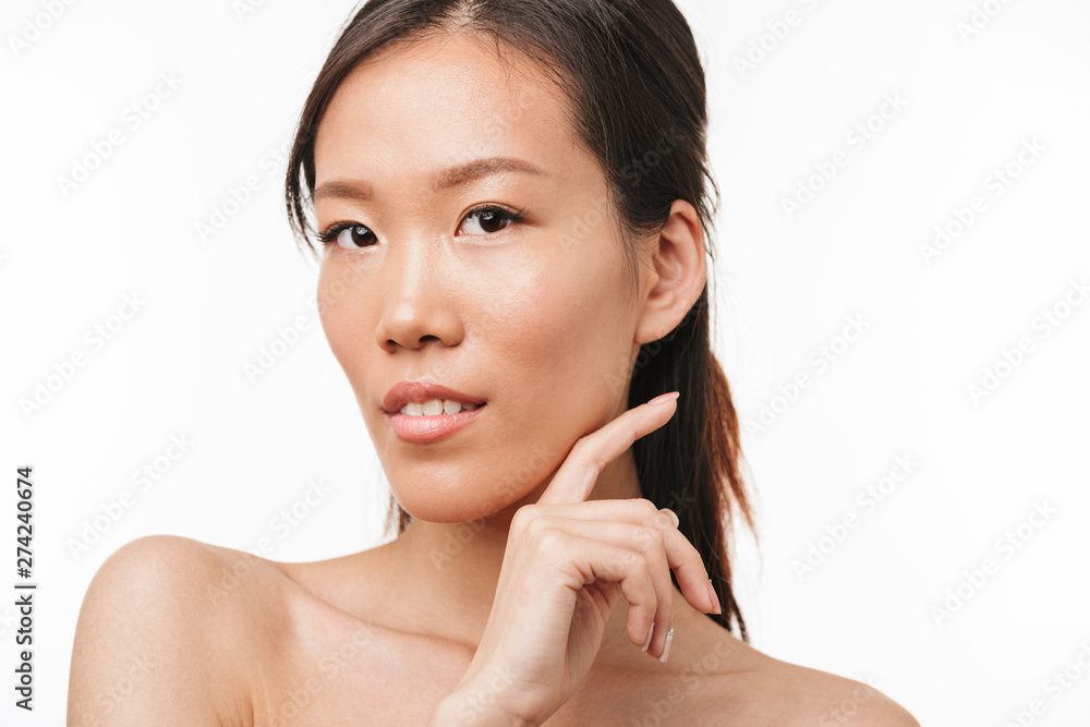 Beautiful positive asian young pretty woman with healthy skin posing isolated over white wall background. Beautiful positive asian young pretty woman with healthy skin posing isolated over white wall background.