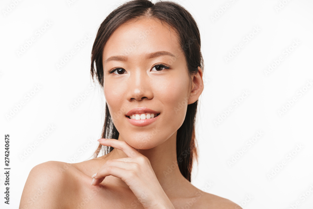 Beautiful positive asian young pretty woman with healthy skin posing isolated over white wall background. Beautiful positive asian young pretty woman with healthy skin posing isolated over white wall background.