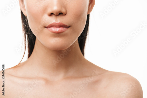 Asian young pretty woman with healthy skin posing isolated over white wall background.