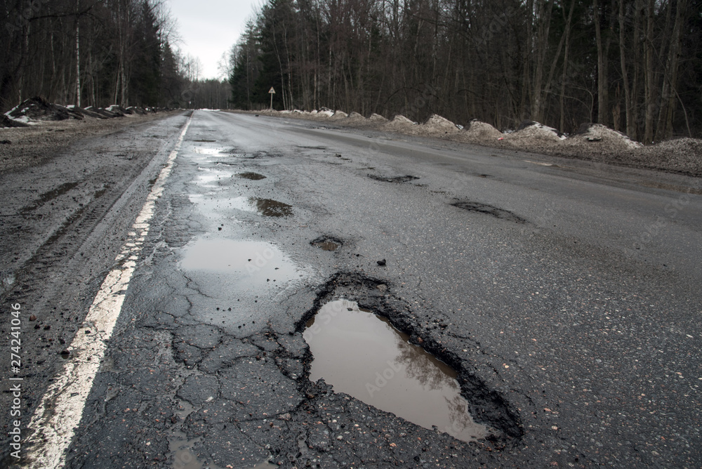 broken road, potholes, puddles, bad russian highway broken road, potholes, puddles, bad russian highway