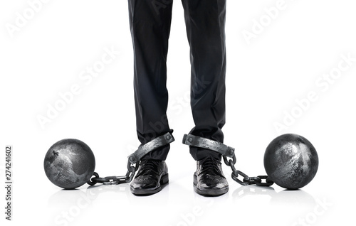 Guilty businessman shackled in the iron ball and chain isolated on white background photo