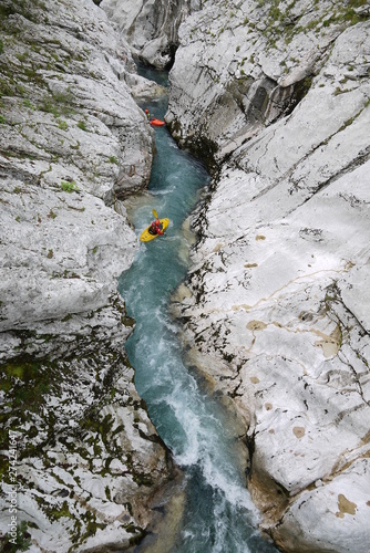 Kayakers paddling down river